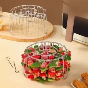 Rundes Spießgestell mit Haken, mit Fleisch und Paprika bestückt, daneben einzelne Spieße