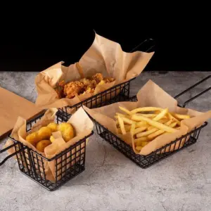 Backpapier in schwarzen Drahtkörben mit Pommes und Nuggets serviert